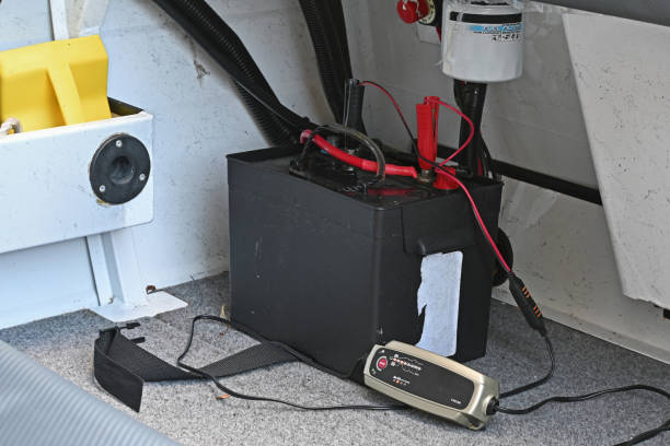 Tarifs/Devis battery in a boat being charged by a small battery charger